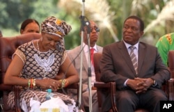 FILE - Grace Mugabe sits next to Vice President Emmerson Mnangagwa at ZANU-PF headquarters in Harare, Feb, 10, 2016.
