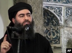 FILE - This image taken from a militant website July 5, 2014, purports to show the leader of the Islamic State group, Abu Bakr al-Baghdadi.