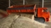 FILE - A driver unloads a truck at a grain storage site during wheat harvesting in the village of Kamennobrodskaya in Russia's Stavropol region, July 4, 2019.