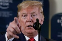 In this Jan. 22, 2020 photo, President Donald Trump speaks during a news conference at the World Economic Forum in Davos, Switzerland. T