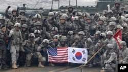 FILE - U.S. and South Korean army soldiers pose on a floating bridge on the Hantan River in Yeoncheon, South Korea, Dec. 10, 2015. 