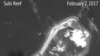 A satellite image shows what CSIS Asia Maritime Transparency Initiative says appears to be concrete structures with retractable roofs on the artificial island Fiery Cross reefs, South China Sea, in this image released on Feb. 22, 2017. 