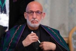 FILE - Former Afghan President Hamid Karzai prepares to attend a meeting in Moscow, Russia, May 28, 2019.