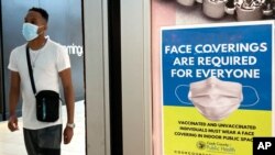 An information sign is displayed at a department store in Rosemont, Ill., Aug. 26, 2021.