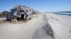 FILE - Homes severely damaged by Superstorm Sandy are seen along the beach in Mantoloking, N.J., April 25, 2013. Mantoloking and Ocean City, N.J., planned to go to court to seize control of narrow strips of beachfront land from property owners blocking a desperately needed protective dune system along New Jersey's 127-mile coast.