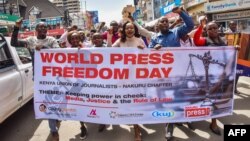FILE - Journalists and activists march during World Press Freedom Day, May 3, 2018, in Nakuru, Kenya. 