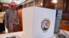 FILE - An observer looks at a voting machine that is to be used in future elections, in Yangon, Malaysia, on Sept. 5, 2023. Myanmar's junta chief said the warring country would hold an election in December 2025 or January 2026, the first since the military staged a coup in 2021.