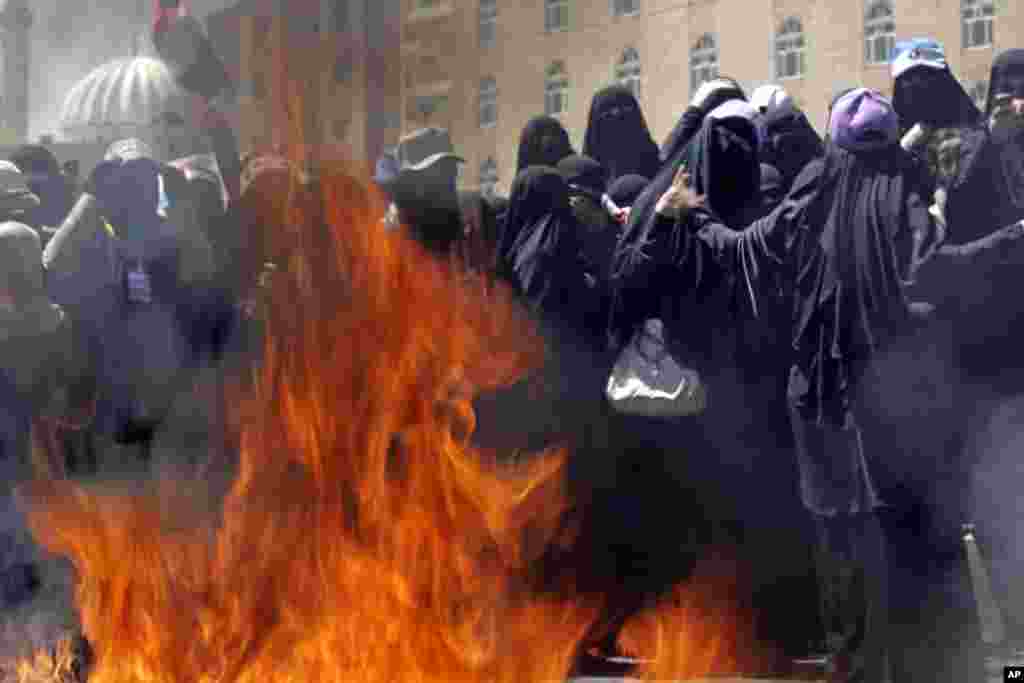 October 26, 2011: Yemeni women protestors burn veils during a demonstration in Sanaa, in a symbolic act meant to attract attention to recent crackdowns by government forces against the popular uprising.