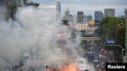 Anti-government demonstrators burn mock body bags, representing casualties of the COVID-19 outbreak and a puppet depicting Thai Prime Minister Prayuth Chan-ocha during an anti-government in Bangkok, Thailand, July 18, 2021.