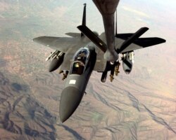 A U.S. Air Force F-15E Strike Eagle refuels in-flight from a KC-135R Stratotanker in the skies over Macedonia, on March 26, 1999, as the two aircraft fly missions in support of NATO Operation Allied Force against targets in the Federal Republic of Yugoslavia.