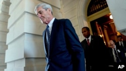 FILE - Former FBI Director Robert Mueller, the special counsel probing Russian interference in the 2016 election, departs Capitol Hill following a closed door meeting in Washington, June 21, 2017.