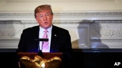 President Donald Trump speaks during a National Day of Prayer dinner gathering in the State Dining Room of the White House in Washington, May 1, 2019.