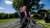 President Donald Trump speaks with reporters before departing on Marine One on the South Lawn of the White House, Aug. 21, 2019, in Washington.