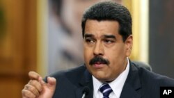 FILE - Venezuelan President Nicolas Maduro speaks during a news conference at Miraflores Presidential Palace in Caracas, Dec. 30, 2014.