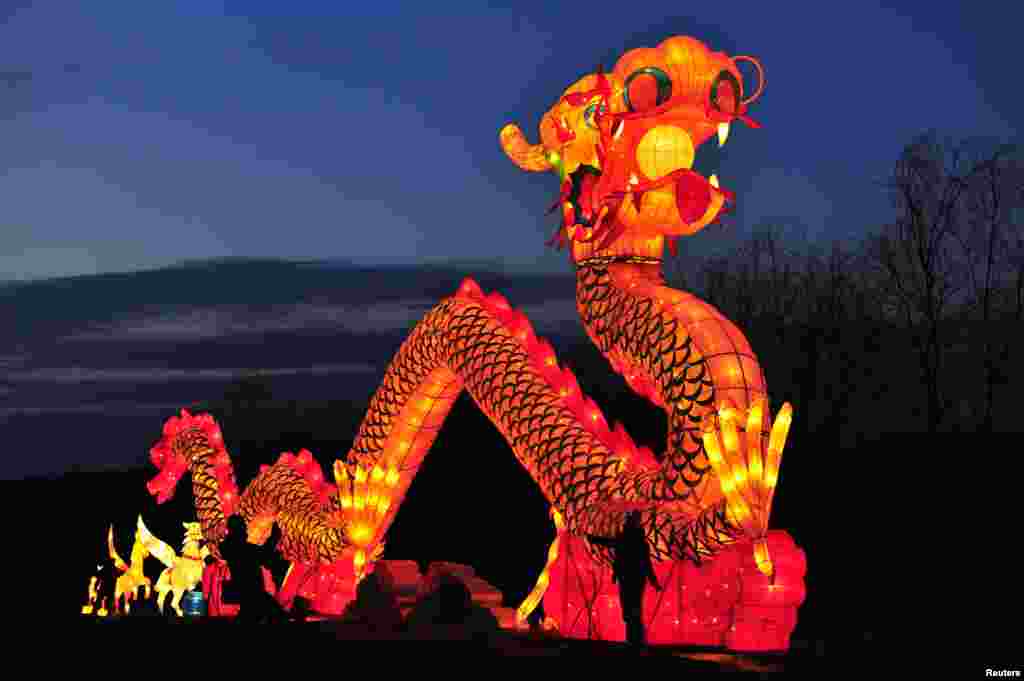 Para wisatawan mengabadikan lentera dragon raksasa dalam festival lentera di kota Shenyang, provinsi Liaoning, China.