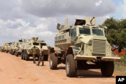 FILE - African Union soldiers stop near Baledogle airfield, Somalia, where they helped secure the area from al-Shabab insurgents, Oct 11, 2012.