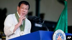 FILE - Philippine President Rodrigo Duterte gestures while addressing army troops during the 120th anniversary celebration of the Philippine Army, April 4, 2017, at Fort Bonifacio.
