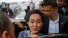 Myanmar Foreign Minister and State Counselor Aung San Suu Kyi leaves a meeting with migrant workers at the coastal fishery center of Samut Sakhon, Thailand, June 23, 2016. 