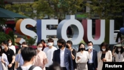 Warga Seoul memakai masker untuk menghindari tertularnya COVID-19 berjalan di zebra cross di Seoul, Korea Selatan, 24 September 2021. (Foto: Reuters)