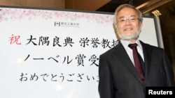 Yoshinori Ohsumi, a professor of Tokyo Institute of Technology smiles in front of a celebration message board after he won the Nobel medicine prize in Yokohama, Japan, October 3, 2016 in this photo released by Kyodo. 