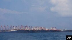 In this photo released March 21, 2021, by the Philippine Coast Guard/National Task Force-West Philippine Sea, some of the 220 Chinese vessels are seen moored at the Whitsun reef, South China Sea, March 7, 2021. 