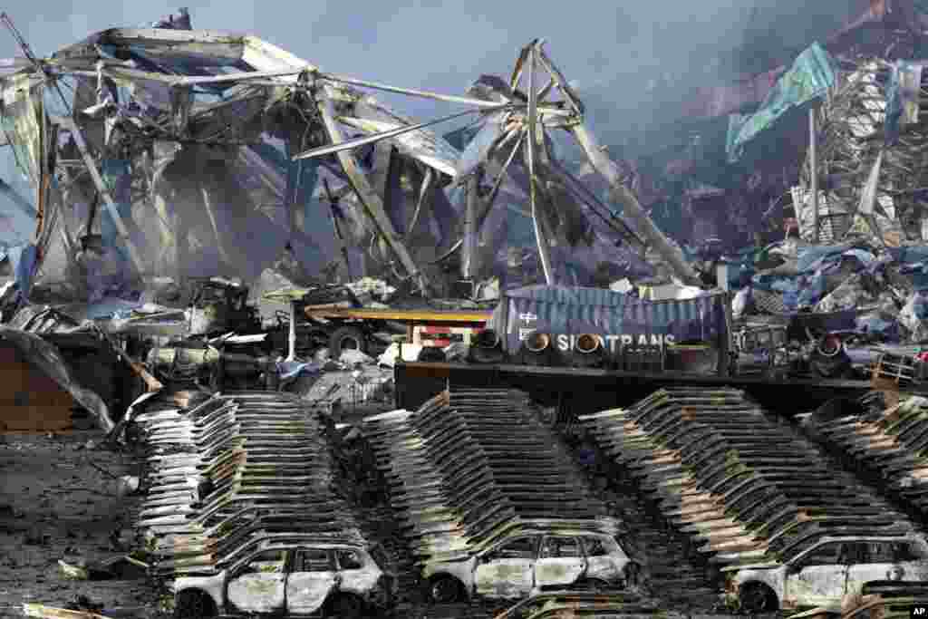 Charred remains of a warehouse and what were new cars after an explosion at a warehouse in northeastern China&#39;s Tianjin municipality, Thursday, Aug. 13, 2015.