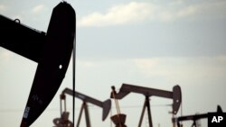 FILE - Pumpjacks are seen in a field near Lovington, New Mexico, April 24, 2015. The U.S. Environmental Protection Agency is expected to roll back requirements on detecting and plugging methane leaks at oil and gas facilities.
