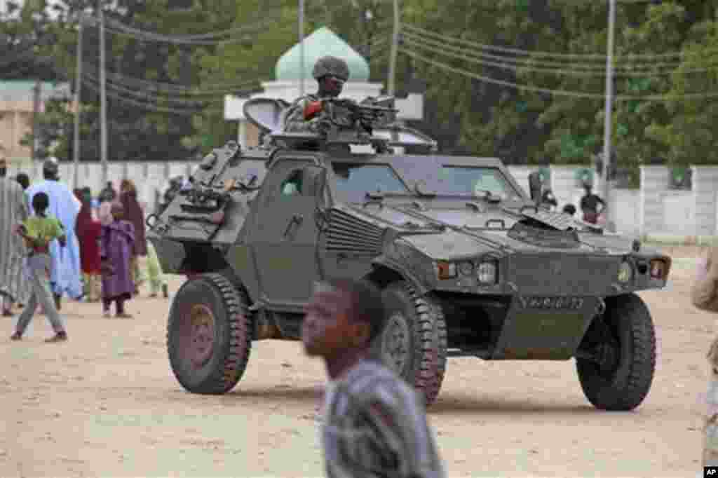 Un soldat nigérian patrouille à bord d’un véhicule blindé, au cours de célébrations de l'Aïd al-Fitr, à Maiduguri, au Nigeria, jeudi 8 août 2013. (AP Photo / Dimanche Alamba, File)