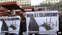 Supporters of far right-wing French politician Jean-Marie Le Pen stand in front of the courthouse in Marseille where Le Pen is accused of inciting racism in the recent anti-Muslim poster campaign by the youth wing of his party, the Front National, 05 Mar