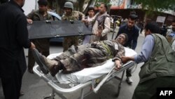 A wounded Afghan man is brought on a stretcher to an Italian aid organization's hospital, as Afghan security forces battled an ongoing attack by Taliban militants on a compound housing an international aid organisation in Kabul on May 8, 2019.