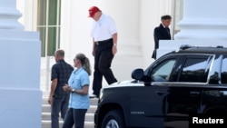 FILE - President Donald Trump, in golf attire, departs the White House for his Trump National Gold Club in Sterling, Virginia, July 14, 2019.