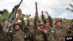 MILF rebels celebrate the signing of the peace agreement during a rally at Camp Darapanan, Sultan Kudarat town, in southern island of Mindanao, March 27, 2014.
