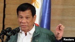 FILE - Philippine President Rodrigo Duterte speaks during a news conference in Davao, Philippines, Sept. 18, 2016. 