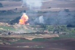 This image taken from a video released by Armenian Defense Ministry on Sept. 28, 2020, allegedly shows fighting between Armenian and Azerbaijani forces at the contact line of the self-proclaimed Republic of Nagorno-Karabakh, Azerbaijan.