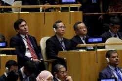 Members of China’s U.N. delegation listen to President Donald Trump deliver remarks to the 74th session of the United Nations General Assembly, in New York, Sept. 24, 2019.
