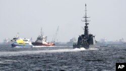 The Republic of Singapore Navy's RSS Brave, right, sails off from the Tuas naval base on a search-and-rescue mission for the USS John S. McCain's missing sailors, Aug. 24, 2017, in Singapore. Aircraft and ships from the navies of Singapore, Malaysia, Indonesia and Australia are searching seas east of Singapore where the collision between the USS John S. McCain and an oil tanker happened Monday.
