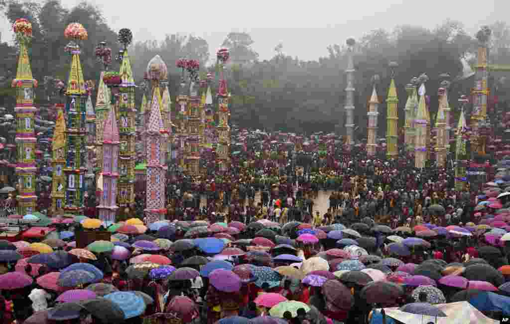 Indian Pnar or Jaintia tribesmen carry 'Rongs' or chariots and dance in muddy waters during Behdienkhlam festival celebrations at Tuber village, in the northeastern Indian state of Meghalaya. Behdienkhlam is a traditional festival of the Pnars celebrated after sowing is done, seeking a good harvest and to drive away plague and diseases.