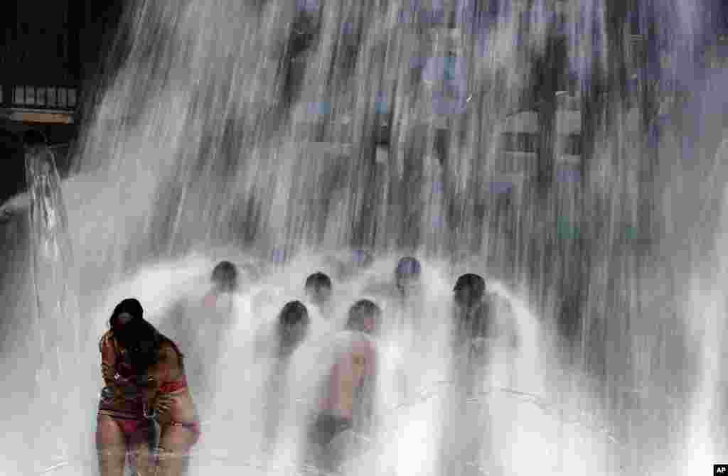People cool off at the water park during the "Circuit" the international gay festival in Vilassar de Dalt, Spain.