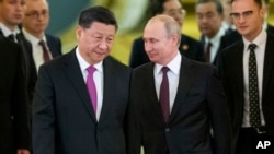 Presiden China Xi Jinping, kiri tengah, dan Presiden Rusia Vladimir Putin, kanan tengah, memasuki aula untuk pembicaraan di Kremlin di Moskow, Rusia, 5 Juni 2019. (Foto: AP)