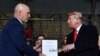 President Donald Trump hands U.S. General John W. Raymond a document after signing the ‘National Defense Authorization Act for FY2020’ at Joint Base Andrews, Maryland, on Dec. 20, 2019.