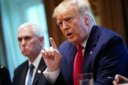 U.S. President Donald Trump and Vice President Mike Pence, left, along with members of the coronavirus take force meet with pharmaceutical executives in the Cabinet Room of the White House in Washington, March 2, 2020.