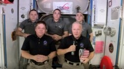 This photo provided by NASA shows, from left, front, astronauts Bob Behnken and Doug Hurley on the International Space Station, Aug. 1, 2020. Behnken and Hurley are scheduled to leave the station in a SpaceX capsule Saturday and splashdown Sunday.
