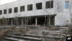 FILE - Houses in the deserted town of Pripyat, some 3 kilometers from the Chernobyl nuclear power plant in Ukraine, Feb. 4, 2020.