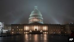 FILE - The U.S. Capitol in Washington is shrouded in mist.