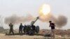 Pasukan keamanan Irak menembakka roket ke arah militan ISIS dari desa di sebelah selatan kota Mosul yang dikuasai ISIS di Irak (26/3).