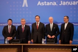 From left, Turkish Foreign Ministry Deputy Undersecretary Sedat Onal, Russia's special envoy on Syria Alexander Lavrentiev, Kazakh Foreign Minister Kairat Abdrakhmanov, UN Syria envoy Staffan de Mistura and Iran's Deputy Foreign Minister Hossein Jaber Ansari stand for a photo after the final statement following the talks on Syrian peace in Astana, Kazakhstan, Jan. 24, 2017.