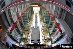 Pesawat Antariksa Shenzhou-9, Roket March-2F dan menara peluncuran roket siap dipindahkan ke lokasi peluncuran di Pusat Peluncuran Satelit Jiuquan, Provinsi Gansu, China. (Foto: Reuters)
