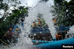 Rescue workers work to pump water out of the Tham Luang cave complex, where members of an under-16 soccer team and their coach have been found alive, in the northern province of Chiang Rai, Thailand, July 5, 2018.