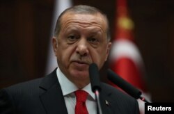 Turkish President Tayyip Erdogan addresses members of parliament from his ruling AK Party (AKP) during a meeting at the Turkish parliament in Ankara, Turkey, July 7, 2018.