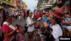 FILE - Vendors sell trinkets in a tourist district of Khao San Road in Bangkok, May 27, 2014.